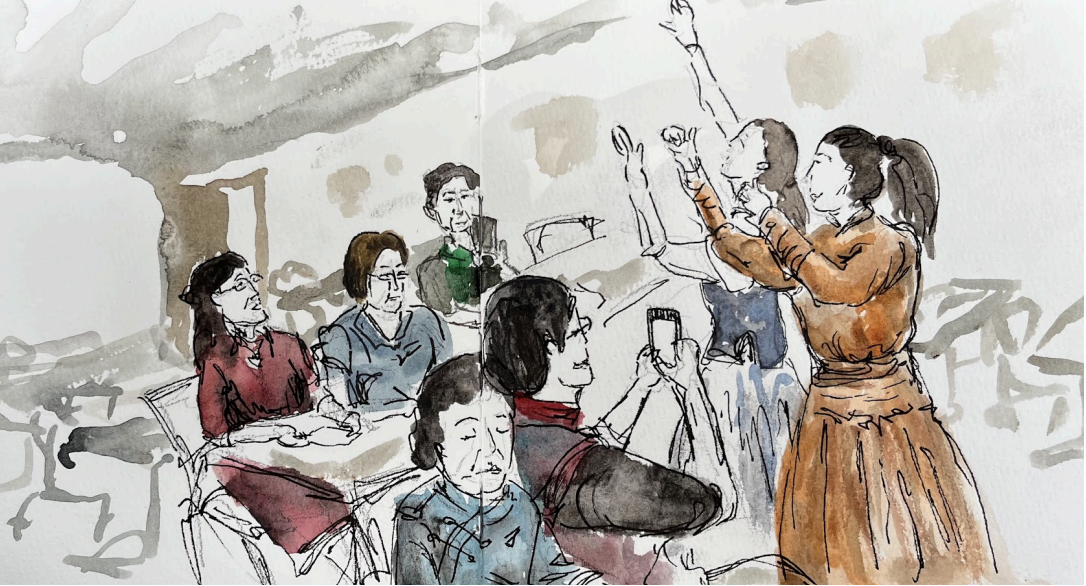 Watercolor sketch of a classroom in Mongolia, China made by student Skylar Hou. Two teachers in dresses at the front of the classroom are dancing with their hands in the air, while the adult students watch from their desks.